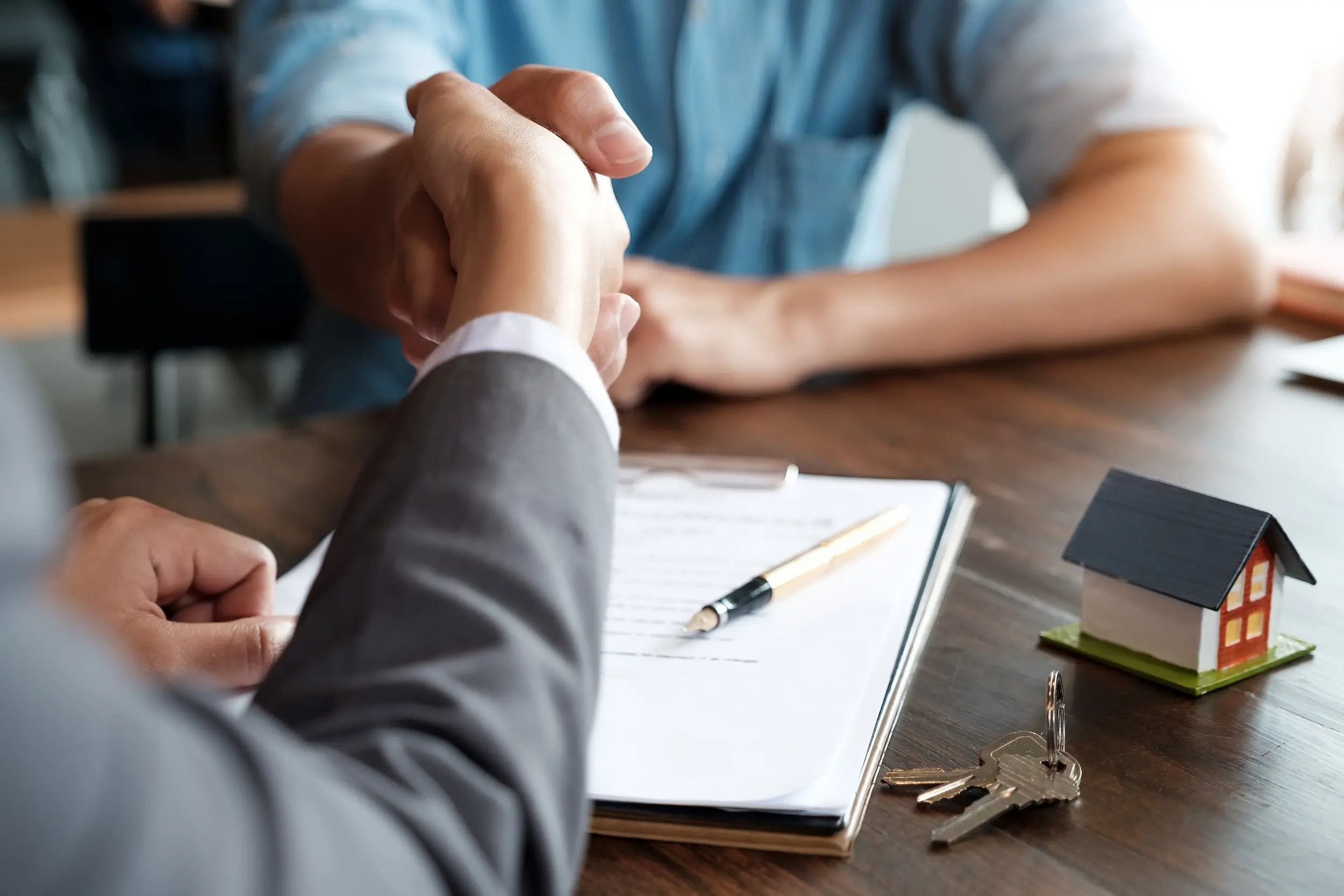 Estate Agent Shaking Hands With His Customer After Contract Signature